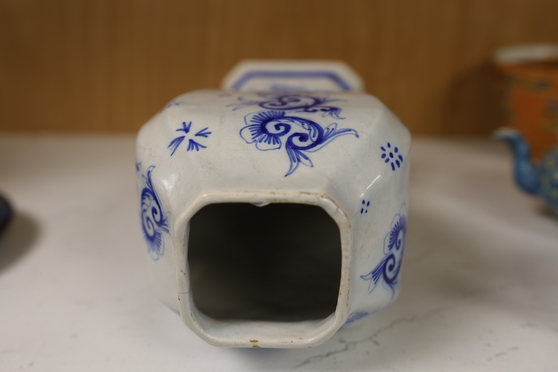 A 19th century Delft blue and white vase and a Watcombe Torquay pottery chamberstick, 19.5cm. Condition - both fair